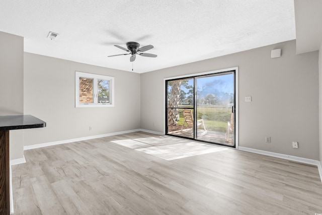 unfurnished living room with ceiling fan, plenty of natural light, and light hardwood / wood-style floors