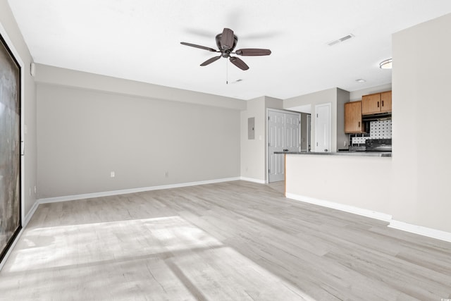 unfurnished living room with light wood-type flooring and ceiling fan