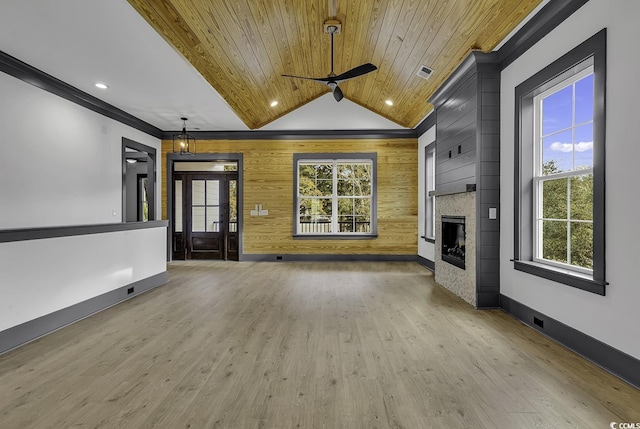 unfurnished living room featuring wooden ceiling, wooden walls, ceiling fan, light wood-type flooring, and a fireplace