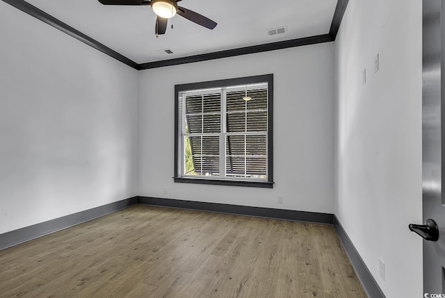 empty room with light wood-type flooring, ceiling fan, and ornamental molding