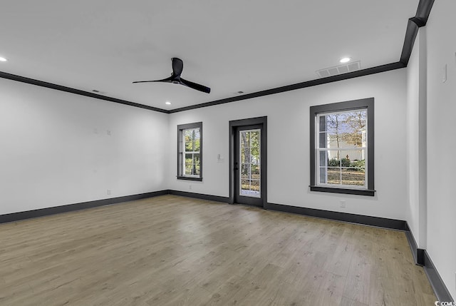 spare room featuring light hardwood / wood-style floors, ceiling fan, and crown molding