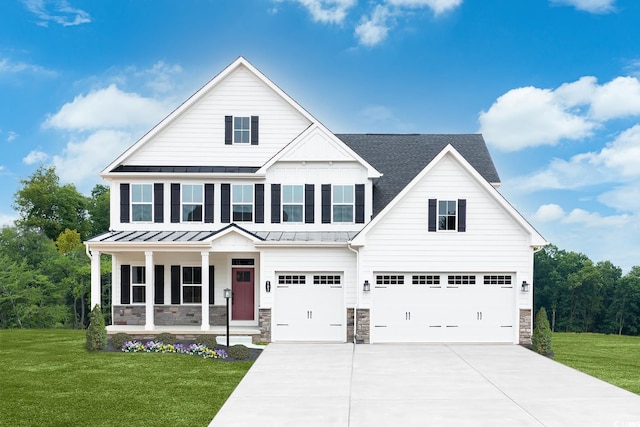 722 Indigo Bay Cir, Myrtle Beach, SC 29579 - view of front of property with a standing seam roof, covered porch, an attached garage, concrete driveway, and a front yard