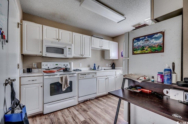 kitchen with a textured ceiling, white appliances, light hardwood / wood-style flooring, and white cabinets