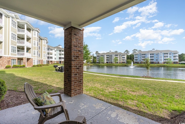 view of patio with a water view and a balcony