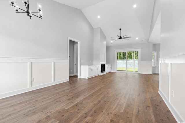309 Waterfall Cir, Little River, SC 29566 - unfurnished living room with a chandelier, high vaulted ceiling, wood finished floors, recessed lighting, and a ceiling fan