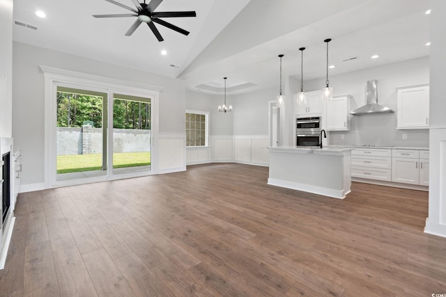 309 Waterfall Cir, Little River, SC 29566 - unfurnished living room with ceiling fan, wood finished floors, wainscoting, a fireplace, and recessed lighting