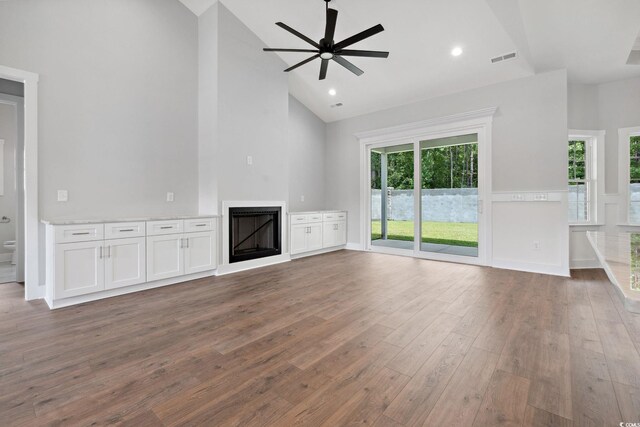 309 Waterfall Cir, Little River, SC 29566 - unfurnished living room with a fireplace, wood finished floors, ceiling fan, and high vaulted ceiling