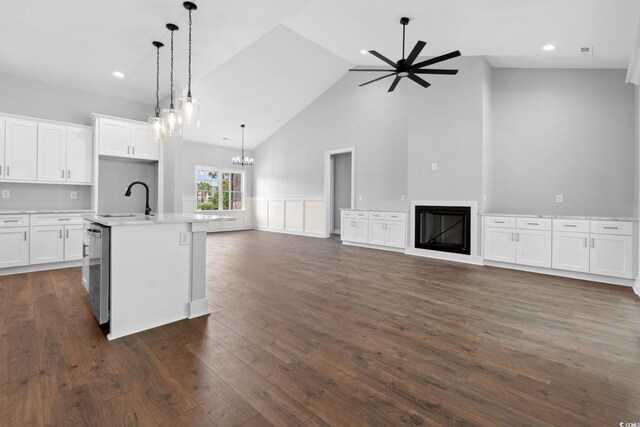 309 Waterfall Cir, Little River, SC 29566 - kitchen with a sink, open floor plan, a glass covered fireplace, ceiling fan, and high vaulted ceiling