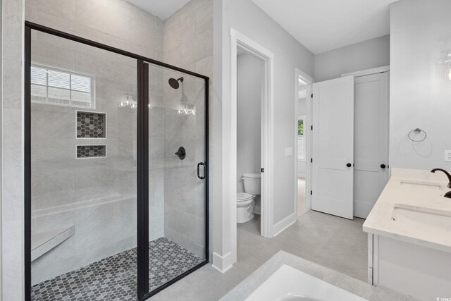 309 Waterfall Cir, Little River, SC 29566 - full bath with toilet, a stall shower, double vanity, and baseboards