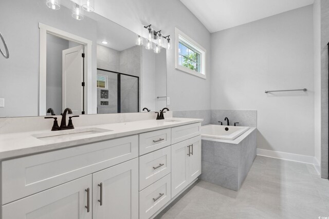 309 Waterfall Cir, Little River, SC 29566 - full bathroom featuring a stall shower, a garden tub, double vanity, and baseboards