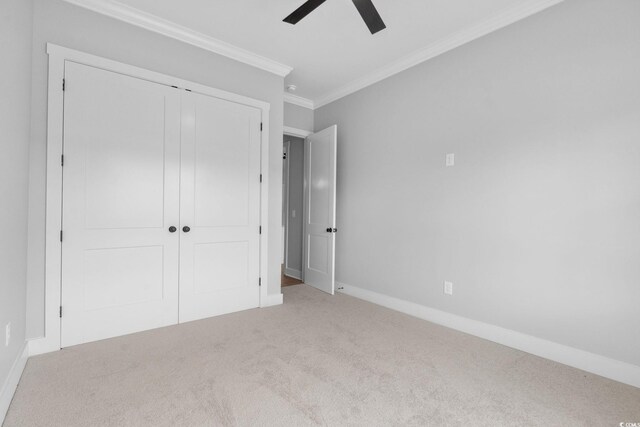 309 Waterfall Cir, Little River, SC 29566 - unfurnished bedroom featuring ornamental molding, carpet, a closet, baseboards, and a ceiling fan