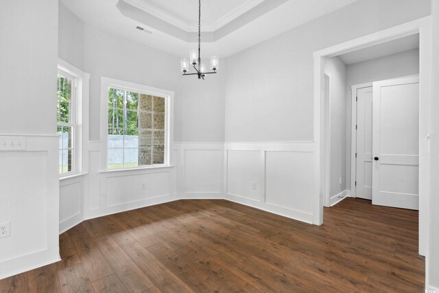 309 Waterfall Cir, Little River, SC 29566 - unfurnished dining area featuring dark wood-style flooring, a chandelier, wainscoting, a raised ceiling, and ornamental molding