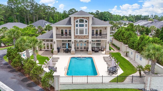309 Waterfall Cir, Little River, SC 29566 - back of house featuring french doors, a balcony, a fenced backyard, and an outdoor living space