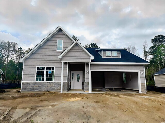 650 Timber Creek Dr, Loris, SC 29569 - view of front of home with stone siding, a garage, and driveway
