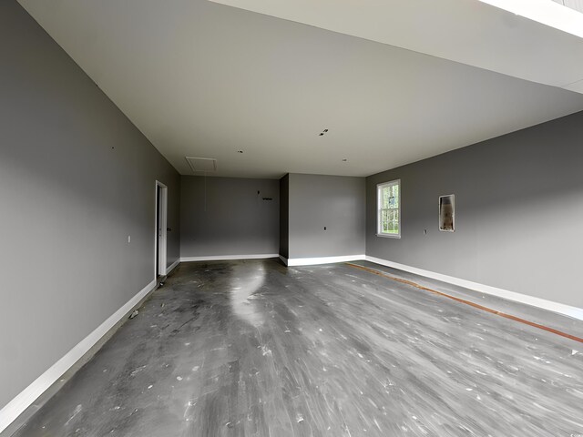 650 Timber Creek Dr, Loris, SC 29569 - spare room featuring attic access, baseboards, and concrete floors