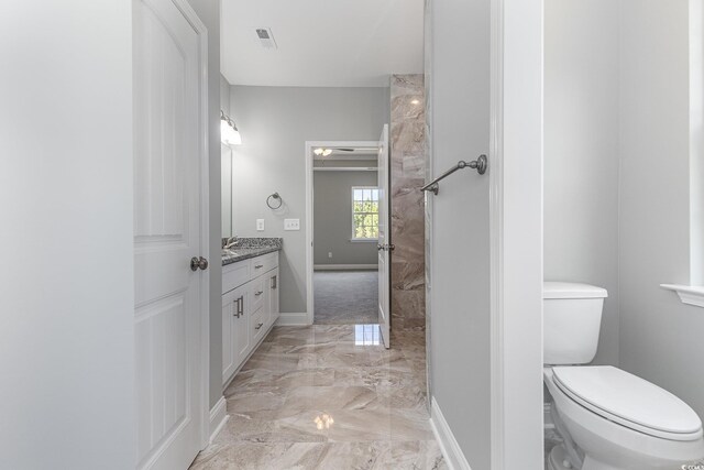 650 Timber Creek Dr, Loris, SC 29569 - bathroom with marble tiled floors, vanity, toilet, and baseboards