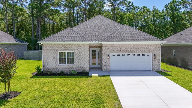 293 Waterfall Cir, Little River, SC 29566 - ranch-style home with brick siding, a garage, concrete driveway, and a front yard
