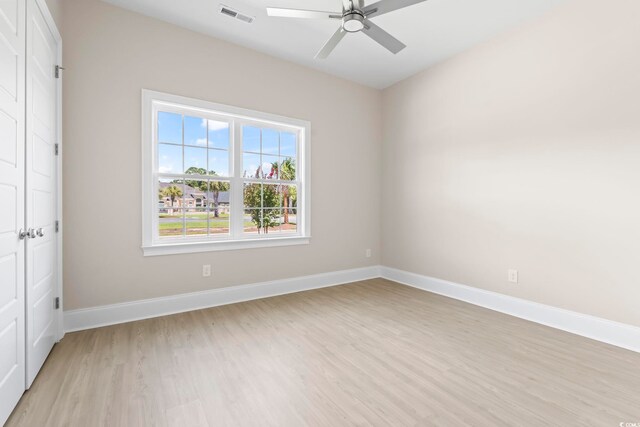 293 Waterfall Cir, Little River, SC 29566 - unfurnished bedroom featuring light wood-type flooring, a closet, and a ceiling fan