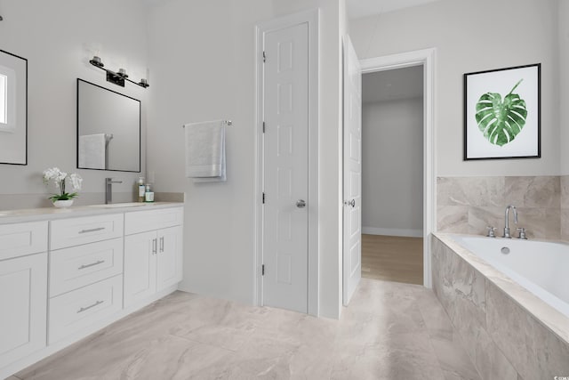 bathroom with a relaxing tiled tub and vanity