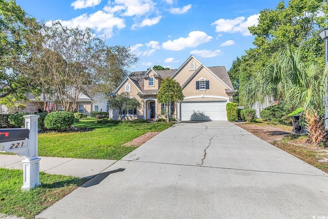 view of front of home with a front yard and a garage