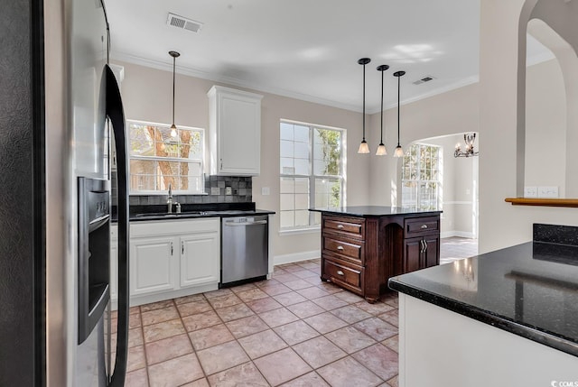 kitchen with sink, dark brown cabinets, white cabinetry, stainless steel appliances, and crown molding