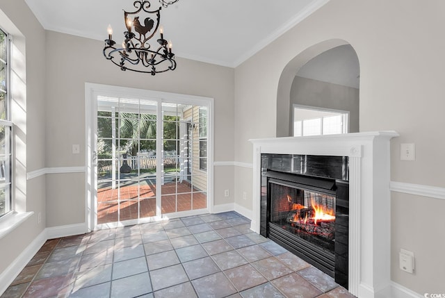 unfurnished living room featuring ornamental molding and a healthy amount of sunlight