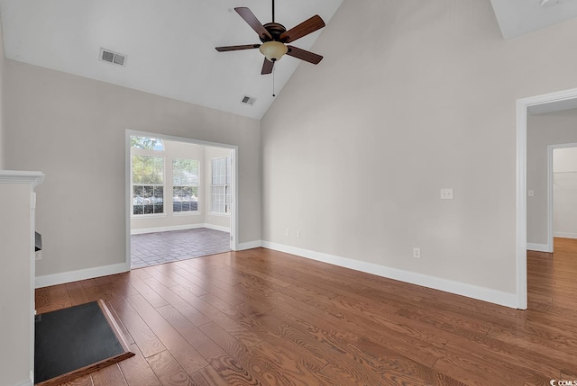 unfurnished living room with hardwood / wood-style flooring, high vaulted ceiling, and ceiling fan