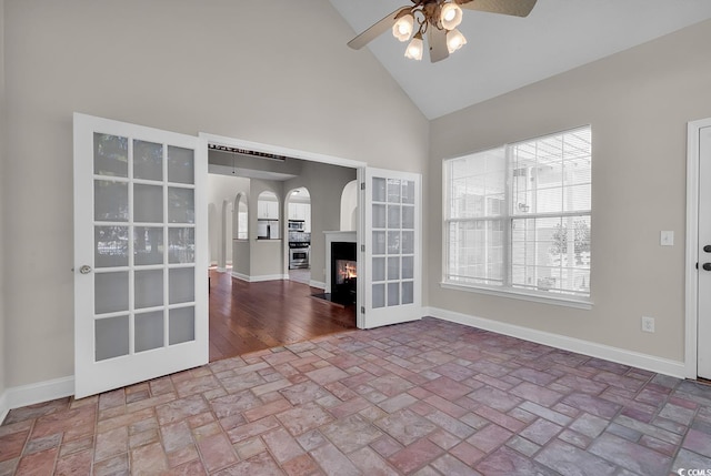 unfurnished living room featuring high vaulted ceiling, ceiling fan, and hardwood / wood-style floors