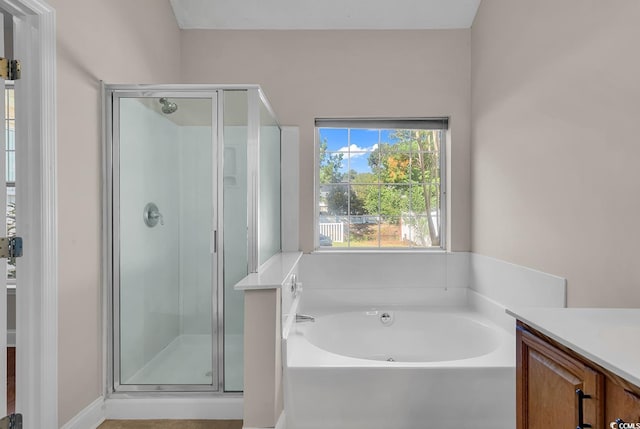 bathroom with vanity and independent shower and bath