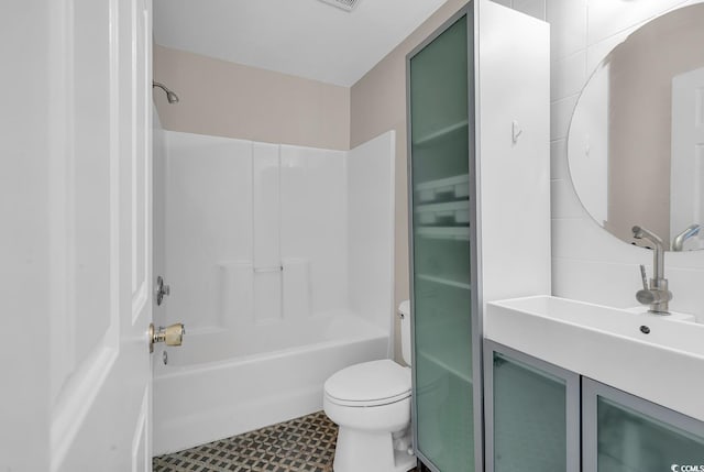 full bathroom featuring tile walls, bathtub / shower combination, vanity, and toilet