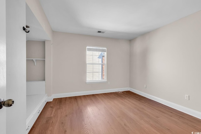 spare room with wood-type flooring