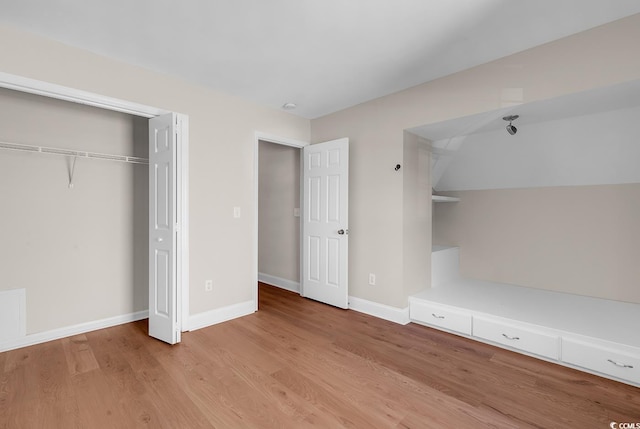 unfurnished bedroom featuring a closet and light hardwood / wood-style flooring