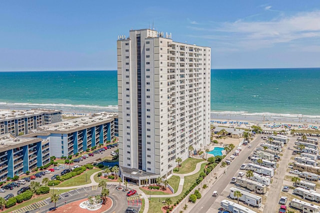 drone / aerial view featuring a water view and a view of the beach