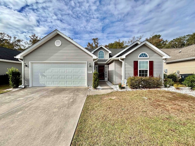 view of front of home with a front yard and a garage