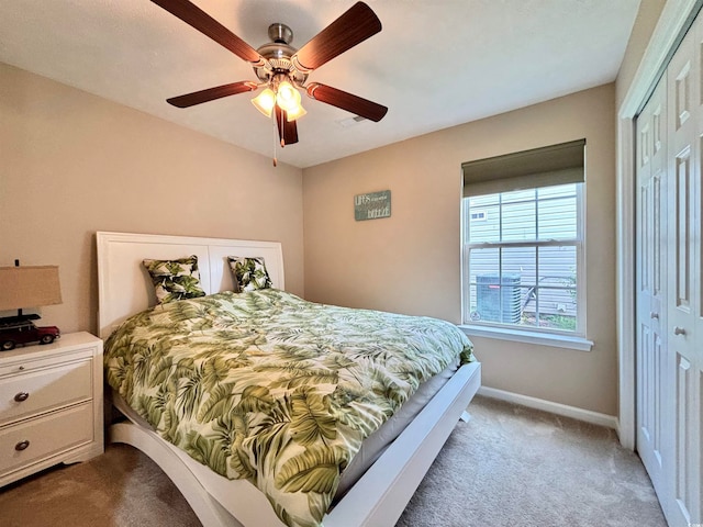 bedroom with a closet, carpet floors, and ceiling fan