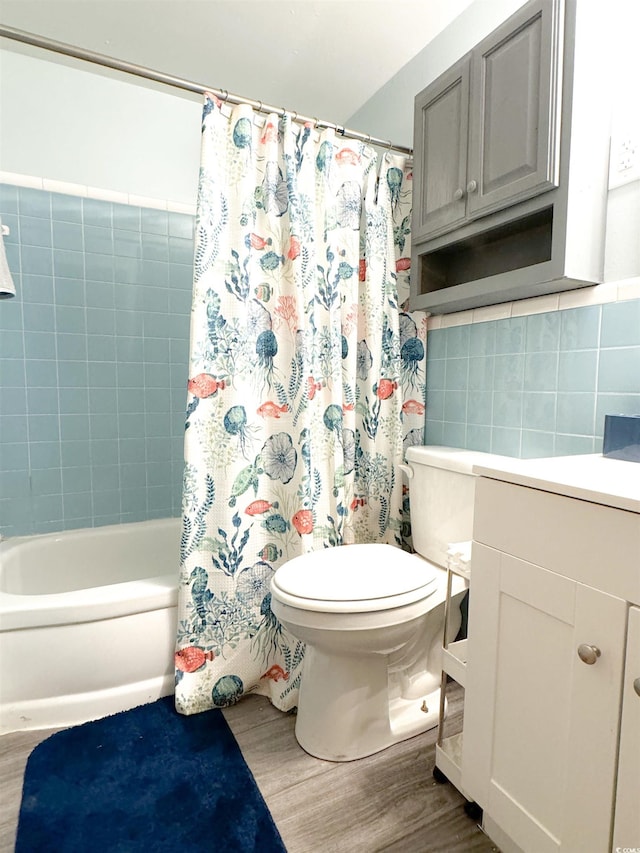 bathroom with shower / bathtub combination with curtain, toilet, tile walls, and wood finished floors