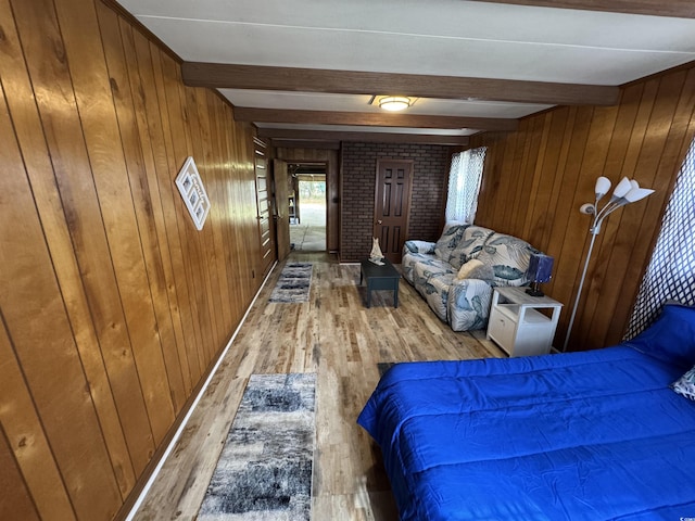 unfurnished bedroom featuring beamed ceiling, wooden walls, and wood finished floors