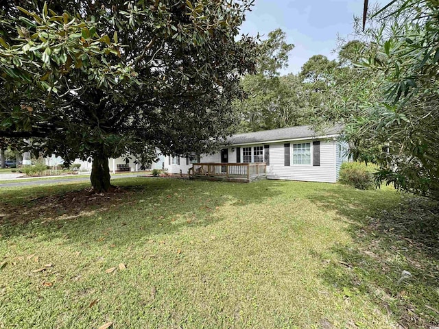 view of front facade with a deck and a front lawn