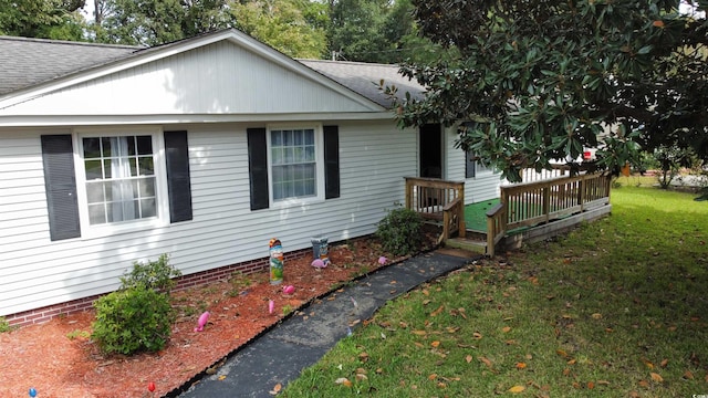 view of home's exterior with a lawn and a shingled roof