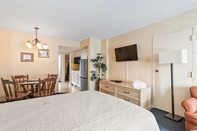 carpeted bedroom with stainless steel refrigerator, a closet, a notable chandelier, and a textured ceiling