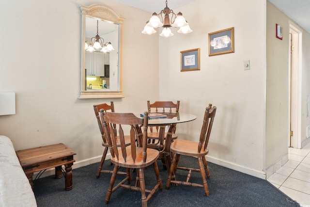 tiled dining room with an inviting chandelier