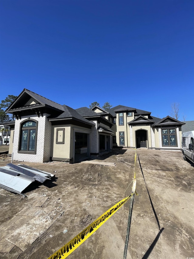 prairie-style home with brick siding and an attached garage