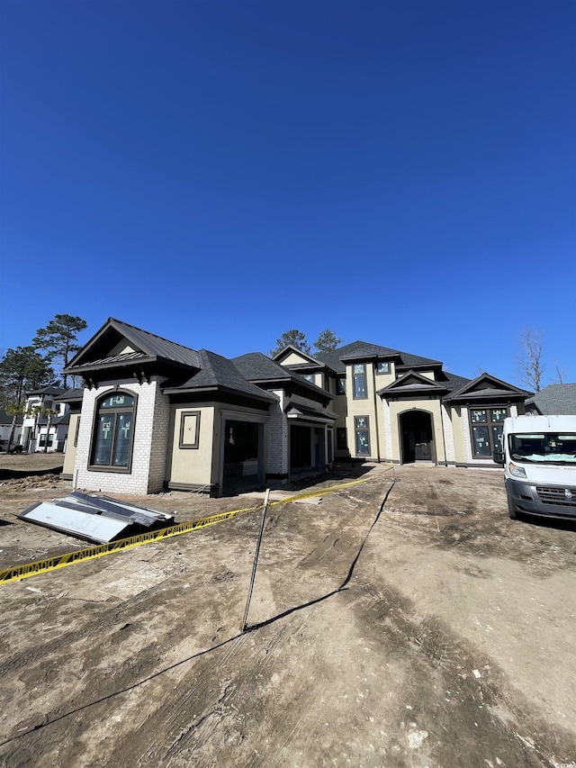 prairie-style house with a garage and brick siding