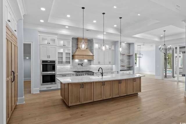 372 Chamberlin Rd, Myrtle Beach, SC 29588 - kitchen with a raised ceiling, crown molding, custom range hood, stainless steel double oven, and decorative backsplash