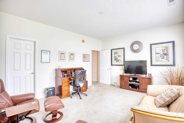 carpeted home office with a textured ceiling and baseboards