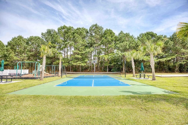 view of home's community with a tennis court and view of scattered trees