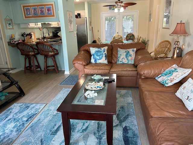 living room featuring hardwood / wood-style flooring and ceiling fan