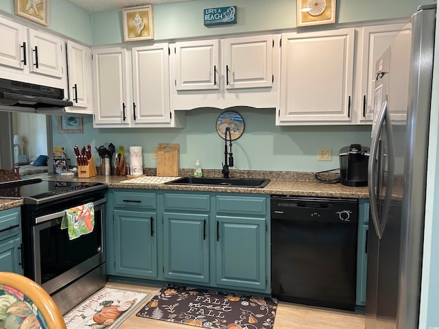 kitchen featuring white cabinets, light hardwood / wood-style flooring, stainless steel appliances, and range hood