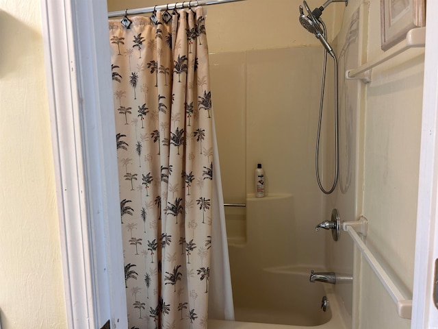 bathroom with shower / bathtub combination with curtain