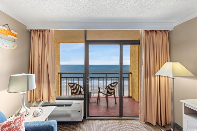 interior space with a water view, crown molding, carpet floors, and a textured ceiling